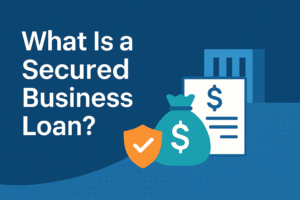 Flat illustration showing icons of money, shield, and loan document with the text “What Is a Secured Business Loan?”